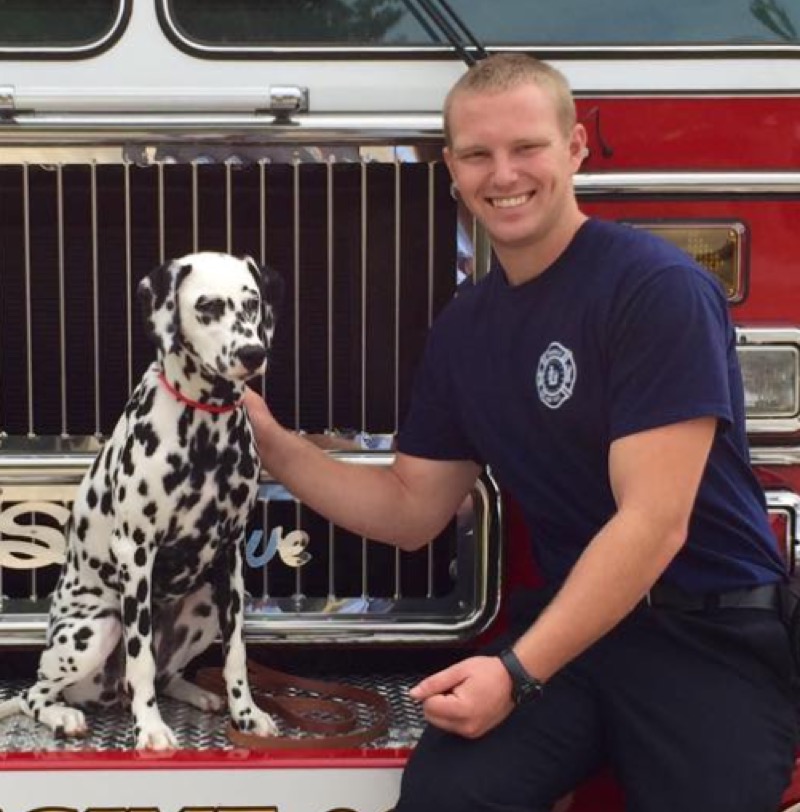 Firefighter holding helmet